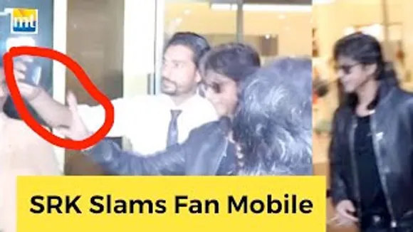 Shah Rukh Khan SLAMS a mobile of a fan trying to take a selfie as he returns from Qatar