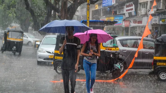 Commuters amid rains, in Navi Mumbai, Monday, May 13, 2024