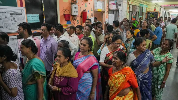 People wait to cast their votes during the 5th phase of Lok Sabha elections, in Mumbai, Monday, May 20, 2024