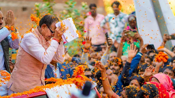 Madhya Pradesh Chief Minister Shivraj Singh Chouhan greets supporters during his visit to Raghogarh