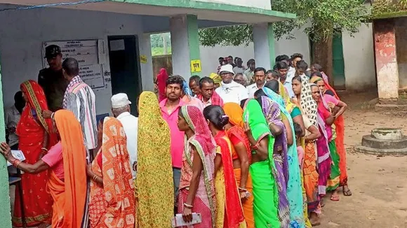 Voters arrive to cast their votes at a polling station during the by-elections to Dumri assembly seat, in Jharkhand's Girdih district