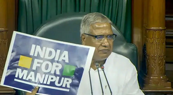 Opposition members display placards in front of the Speaker's chair in a protest in the Lok Sabha over the Manipur issue, during the Monsoon session of Parliament, in New Delhi