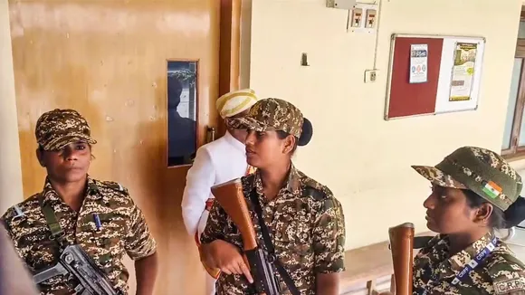 Security personnel stand guard during a raid by the Enforcement Directorate on the Mysuru Urban Development Authority (MUDA) office in connection with a money laundering case, in Mysuru, Karnataka, Friday, Oct. 18, 2024.