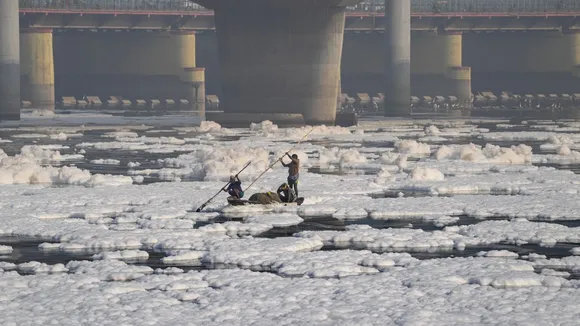 People at the Yamuna bank as toxic foam floats on the surface of the polluted Yamuna river, at Kalindi Kunj, in New Delhi, Saturday, Oct 19, 2024