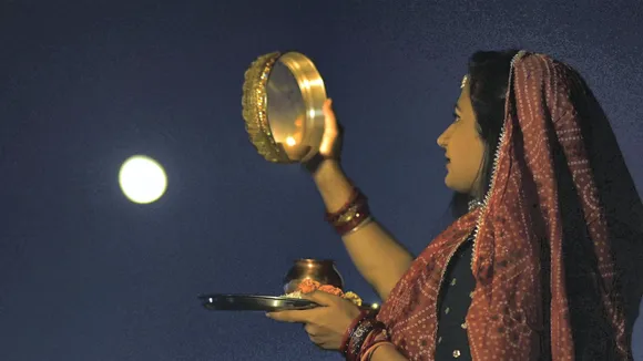 A woman performs rituals on the occasion of 'Karva Chauth', in Bhopal, Sunday, Oct. 20, 2024.