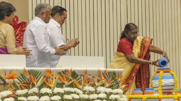 President Droupadi Murmu pours water into a pot during the 5th National Water Awards ceremony, in New Delhi, Tuesday, Oct. 22, 2024