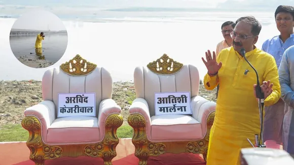 Delhi BJP President Virendra Sachdeva stands beside two chairs arranged for Delhi Chief Minister Atishi and AAP National Convener Arvind Kejriwal during BJP's protest in New Delhi, Thursday, Oct. 24, 2024