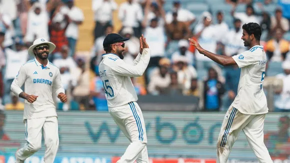 Washington Sundar celebrates with captain Rohit Sharma and Ravindra Jadeja after taking the wicket of New Zealand's Rachin Ravindra, in Pune, Thursday, Oct. 24, 2024