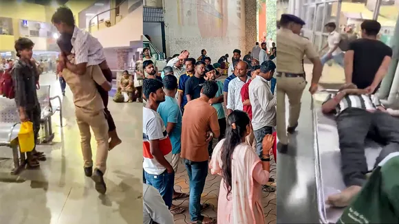 A police official carries an injured passenger after a stampede at Bandra railway station, in Mumbai, Sunday, Oct. 27, 2024.
