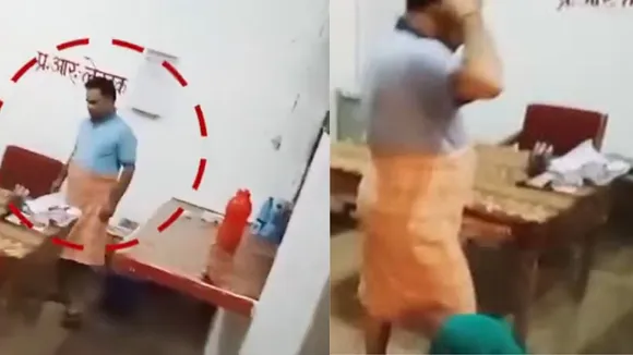 Screenshot from a video of a sub inspector showing him ill-treating a woman while being clad in a 'lungi'