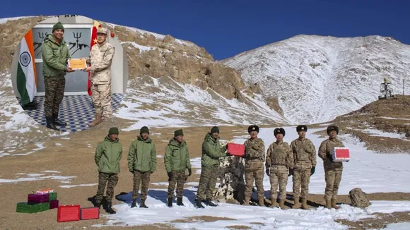 Indian and Chinese Army personnel exchange sweets on the Diwali festival, at the KK Pass