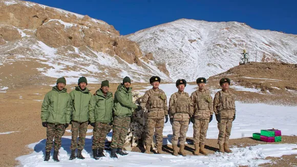 Indian and Chinese Army personnel exchange sweets on the Diwali festival, at the KK Pass.