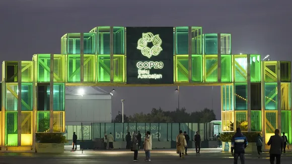 People walk outside the venue for the COP29 U.N. Climate Summit in Baku, Azerbaijan