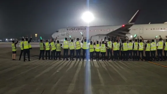 Employees wave at a Vistara plane on the last day of the airline's operation before its integration with Air India, in Ahmedabad, Monday, Nov 11, 2024.