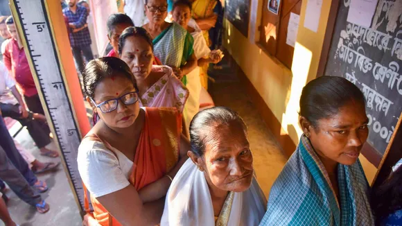 Voters wait in a queue at a polling station to cast votes during Samaguri assembly constituency bypoll, in Nagaon district of Assam, Wednesday, Nov 13, 2024.