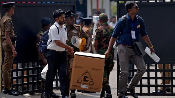 Polling officials and police officers carry election materials after collecting them from a distribution centre, a day before the Parliamentary Election, in Colombo, Sri Lanka, November 13, 2024.