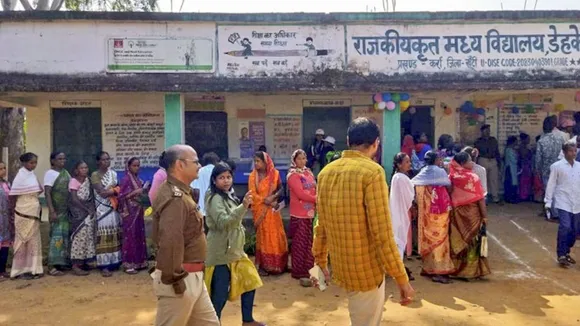 People wait to cast their votes during the first phese of Jharkhand Assembly elections, in Ranchi, Wednesday, Nov. 13, 2024