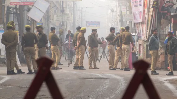 Security personnel keep vigil near a polling booth during UP's Assembly bypolls, Wednesday, Nov. 20, 2024.
