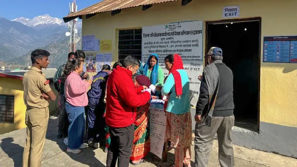 Voters wait to cast votes at a polling booth during the Kedarnath Assembly constituency bypoll, in Rudraprayag, Uttarakhand.