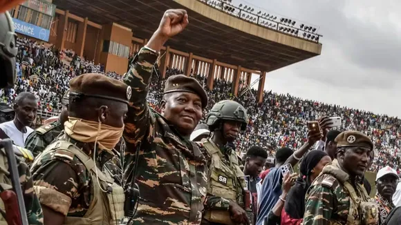 Gen Abdourahamane Tiani (second left), the head of the military regime in Niger, greets a crowd in Niamey in July 2024. Boureima Hama