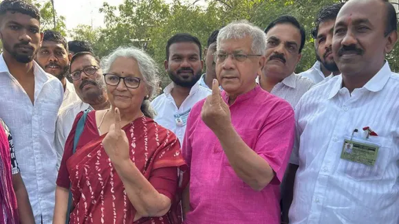 Vanchit Bahujan Aaghadi President Prakash Ambedkar and his wife show their fingers marked with indelible ink after casting votes during the Maharashtra Assembly elections, in Akola district, Wednesday, Nov. 20, 2024.