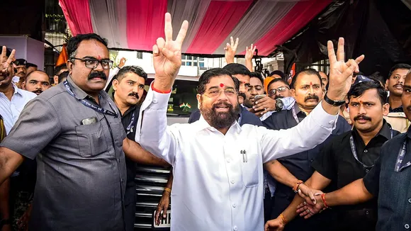 Maharashtra Chief Minister Eknath Shinde with supporters flashes victory signs as the BJP-led Mahayuti alliance leads amid the counting of votes for the Maharashtra Assembly elections, in Thane.
