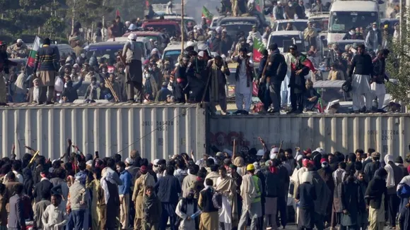 Supporters of imprisoned former premier Imran Khan's Pakistan Tehreek-e-Insaf party, remove shipping container to clear way for their rally demanding Khan's release, in Islamabad, Pakistan