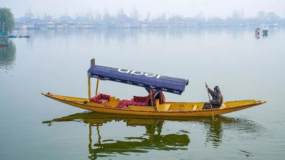 A Shikarawala sails an Uber 'Shikara' across Dal Lake, in Srinagar. Uber has launched its water transport service in India, with a booking of a shikara at Dal Lake in Srinagar through its app.