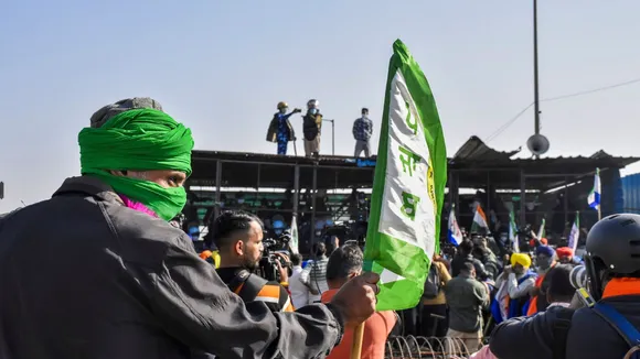 Farmers move towards barricades put up by security forces after commencing their foot march to Delhi, at Shambhu border, in Patiala district, Punjab, Friday, Dec. 6, 2024.