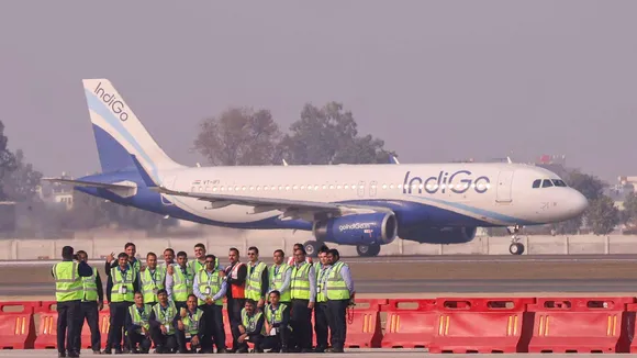 Airport officials pose for a photograph after the successful landing of the first test flight at Noida International Airport, at Jewar in Gautam Buddha Nagar district, Uttar Pradesh, Monday, Dec. 9, 2024