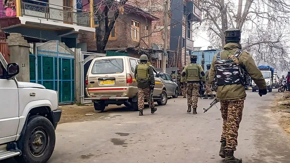 Security forces personnel guard as NIA conducts raids at a locationn in a terror funding case, in Anantnag, Thursday, Dec. 12, 2024.