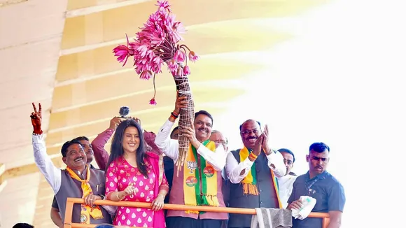 Devendra Fadnavis with his wife Amruta Fadnavis during a roadshow, in Nagpur, Sunday, Dec. 15, 2024.
