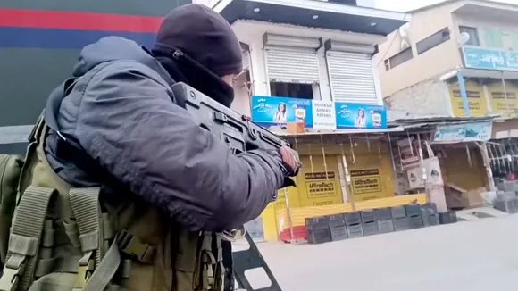 A security personnel takes position during an encounter with terrorists at Kadder in the Behibagh area of Kulgam district, J & K, Thursday, Dec. 19, 2024.