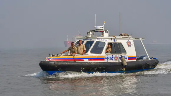 Security personnel during a search operation for missing passengers, two days after a ferry-Navy craft collision, in Mumbai