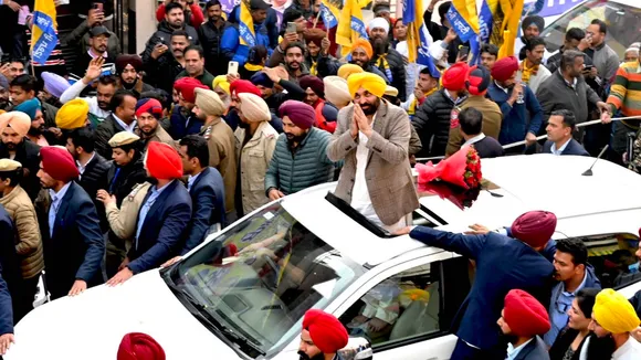 Punjab Chief Minister Bhagwant Mann greets supporters during a roadshow in support of Aam Aadmi Party (AAP) candidates ahead of the state Municipal Corporation elections in Patiala on Thursday, Dec. 19, 2024.