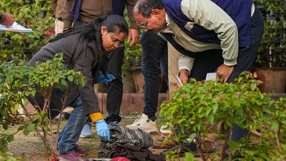 Members of the forensic team of Delhi Police Crime Branch conducts investigation at the spot where a man tried to immolate himself near the Railway Bhawan opposite the new Parliament building in New Delhi on Wednesday, Dec. 25, 2024. 
