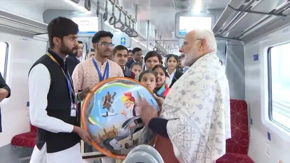 Narendra Modi interacts with children and people as he takes a ride on a Namo Bharat train from Sahibabad station to New Ashok Nagar station on Sunday, Jan 5, 2025.