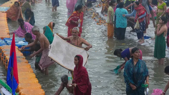 Devotees take a holy dip on the first day of Maha Kumbh Mela 2025, in Prayagraj, Uttar Pradesh, Monday, Jan. 13, 2025.