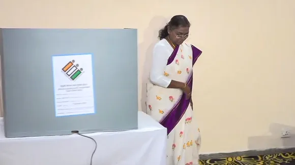 President Droupadi Murmu gets her finger marked with indelible ink before casting her vote at a polling booth during the Delhi Assembly elections, in New Delhi, Wednesday, Feb. 5, 2025.