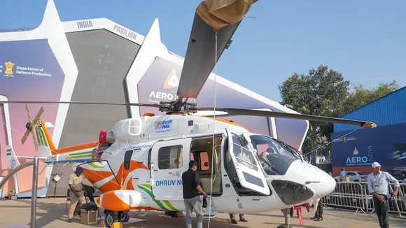 HAL staffers work on a Dhruv helicopter ahead of the Aero India 2025, at the Yelahanka Air Force Station in Bengaluru on Sunday, Feb. 9, 2025.