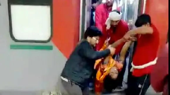 A woman, who fell unconscious, being taken on a trolly from a train, at the New Delhi railway station, Saturday, Feb. 15, 2025.