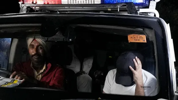 Indians deported from the U.S. being escorted by the police as they leave the airport upon their arrival in Amritsar on early Sunday, Feb. 16 , 2025.