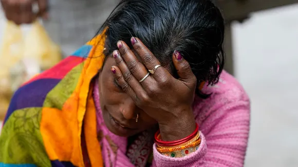 A relative of Poonam Devi, a woman from Bihar's Chapra who died in New Delhi railway station stampede, mourns outside the mortuary at the LNJP Hospital in New Delhi on Sunday, Feb. 16, 2025. 