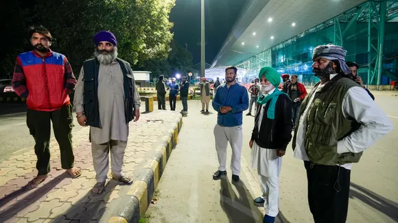 Relatives wait outside the airport ahead of the second batch of the immigrants' arrival from the US in Amritsar on Saturday, Feb. 15,