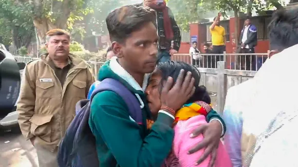 Relatives of victims wait outside the mortuary at the LNJP Hospital in New Delhi on Sunday, Feb. 16, 2025.