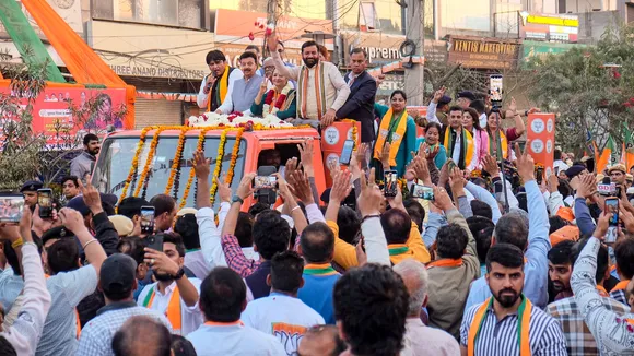 Haryana Chief Minister Nayab Saini campaigns for BJP mayoral candidate Rajrani Malhotra during a roadshow ahead of the Municipal Corporation Gurugram Mayor elections in Gurugram on Sunday, Feb. 23, 2025.