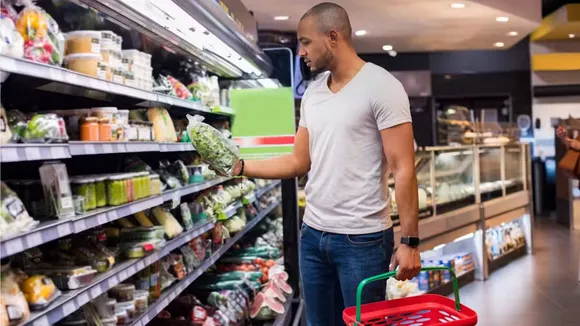 Consumer buying vegetables in store image