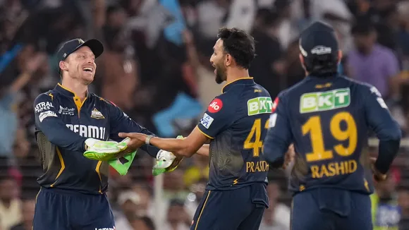 Gujarat Titans' Prasidh Krishna celebrates with Jos Buttler after taking the wicket of Rajasthan Royals’ captain Sanju Samson at the Narendra Modi Stadium in Ahmedabad on Wednesday, April 9, 2025.