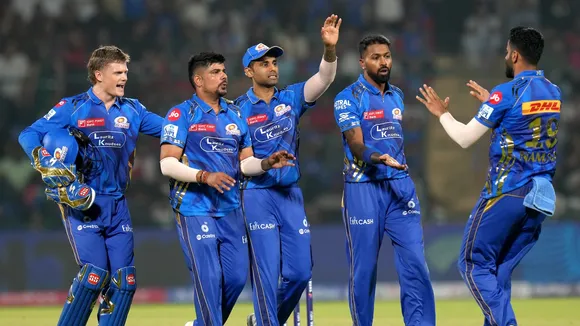 Mumbai Indians' Karn Sharma celebrates with teammates after taking the wicket of Delhi Capitals' Tristan Stubbs at the Arun Jaitley Stadium in New Delhi on Sunday, April 13, 2025.
