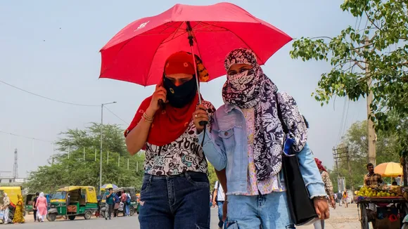 Young women protect themselves from the sun on a hot summer day.